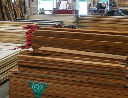 Stacks of quality lumber in a warehouse. Contact Cygnus Lumber for wood inquiries.