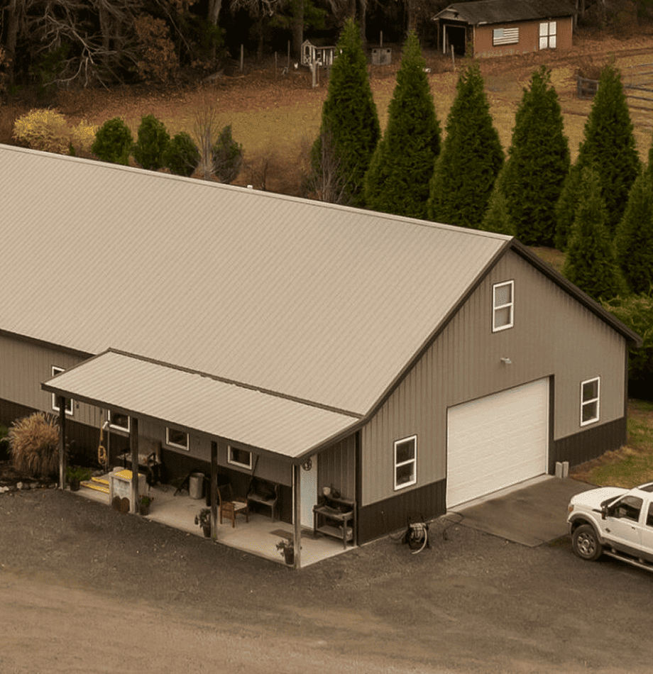 Large modern grey building with white garage door for Cygnus Lumber operations, truck parked outside.