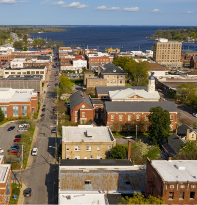 Aerial view of a coastal town with historic brick buildings.