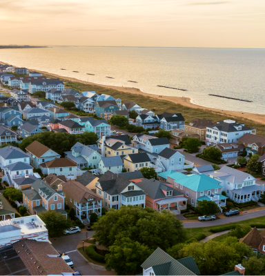 Virginia Beach: Aerial view of beachfront houses along the coast during sunset.