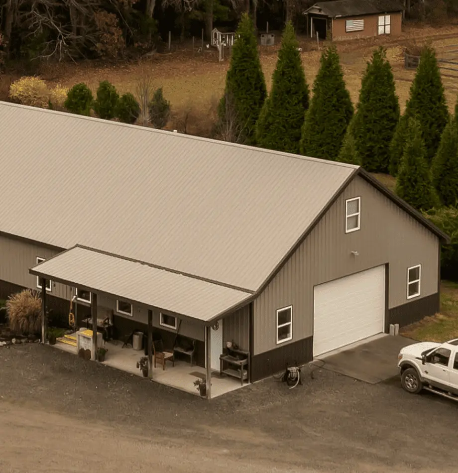 Large modern grey building with white garage door for Cygnus Lumber operations, truck parked outside.